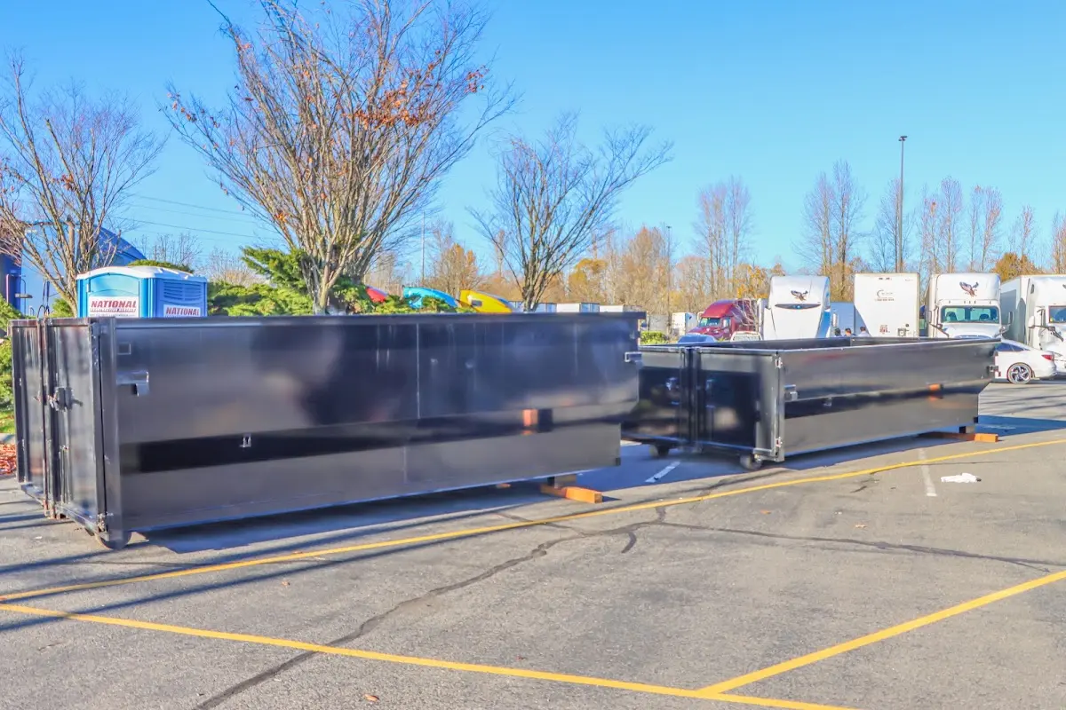 Professional dumpster rental service with roll-off container on residential driveway in Tega Cay